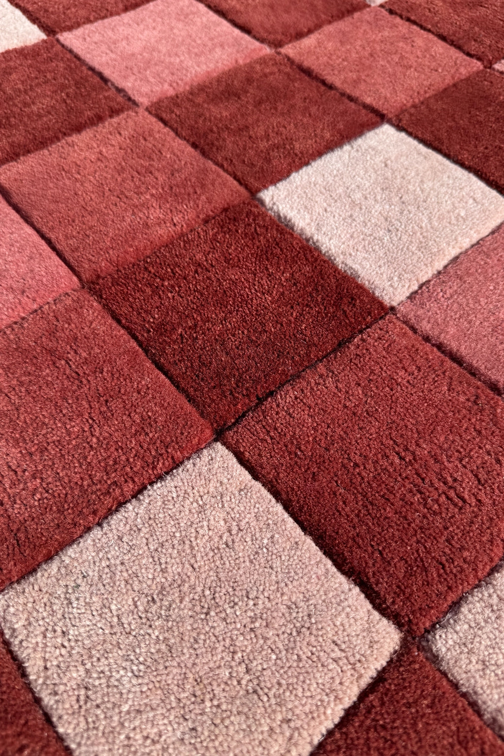 Square patchwork rug with red and beige squares texture