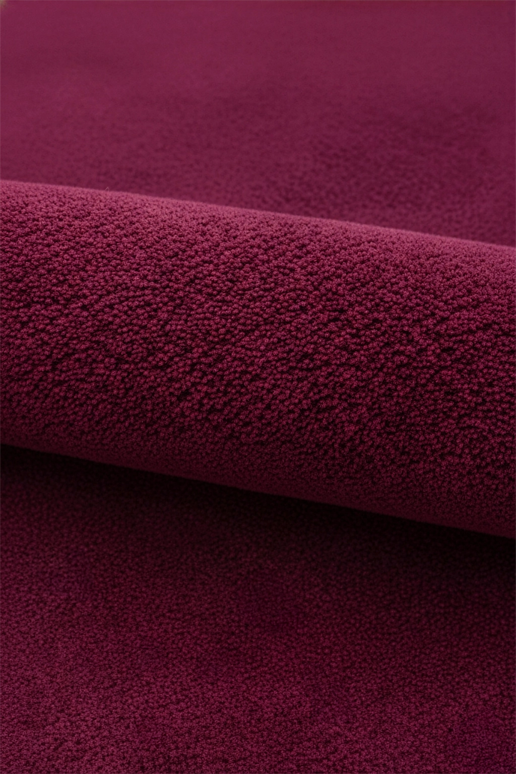 Close-up of burgundy purple pink wool rug texture