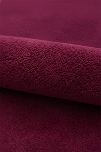 Close-up of burgundy purple pink wool rug texture
