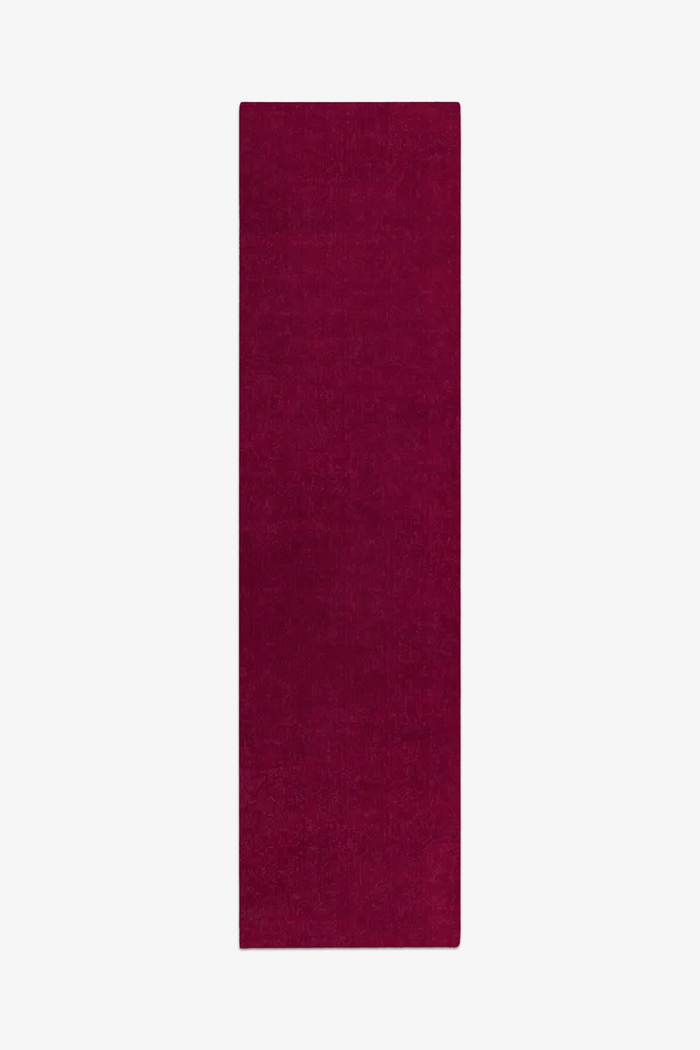burgundy pink runner rug on a white background