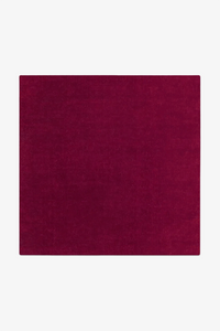 Solid burgundy rug on a white background