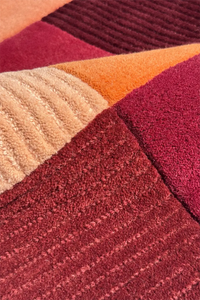 Close-up of a textured wool rug with multicolored pattern