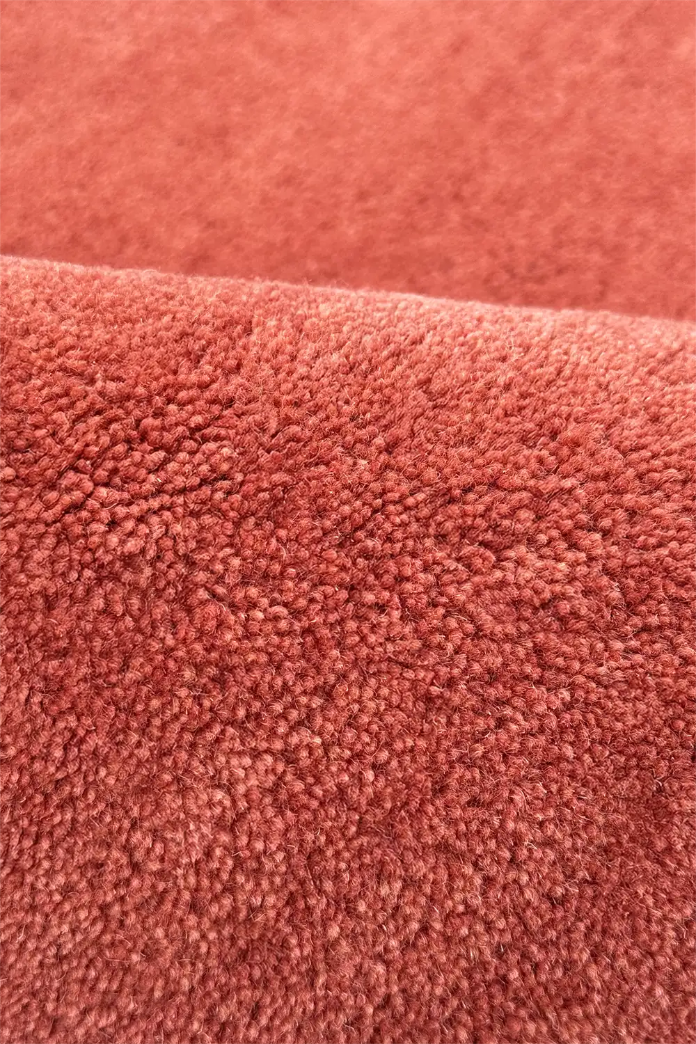 Close-up of a textured rust hand tufted wool runner rug