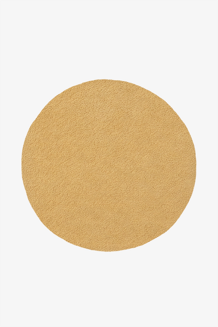 yellow round wool rug with soft buttery surface hand-tufted in natural materials