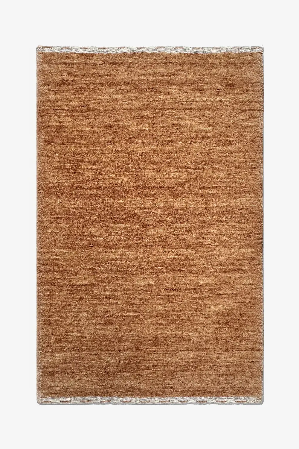 warm camel brown textured wool rug on a white background
