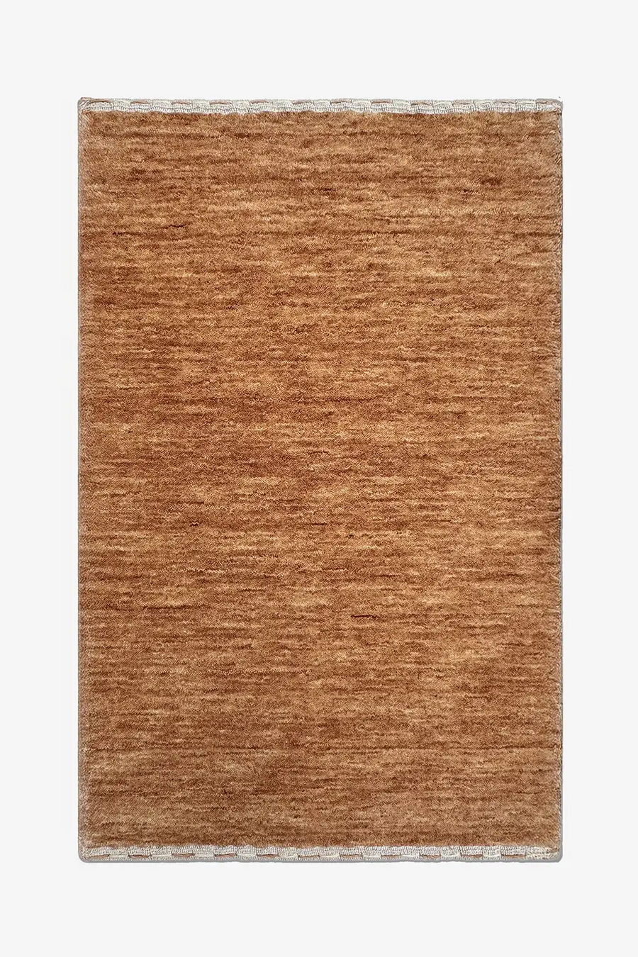 warm camel brown textured wool rug on a white background