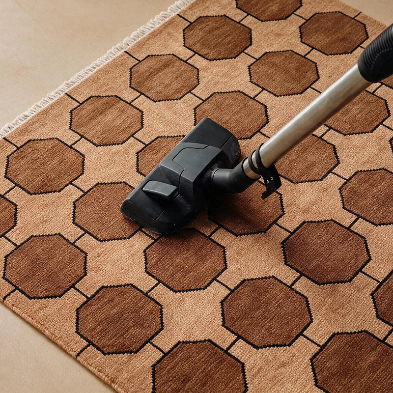 Vacuuming a honey gold Octagon Link wool rug with a suction-only vacuum head