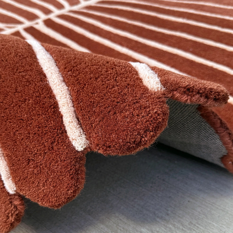 Carved leaf detail on a hand-tufted Fronda wool rug