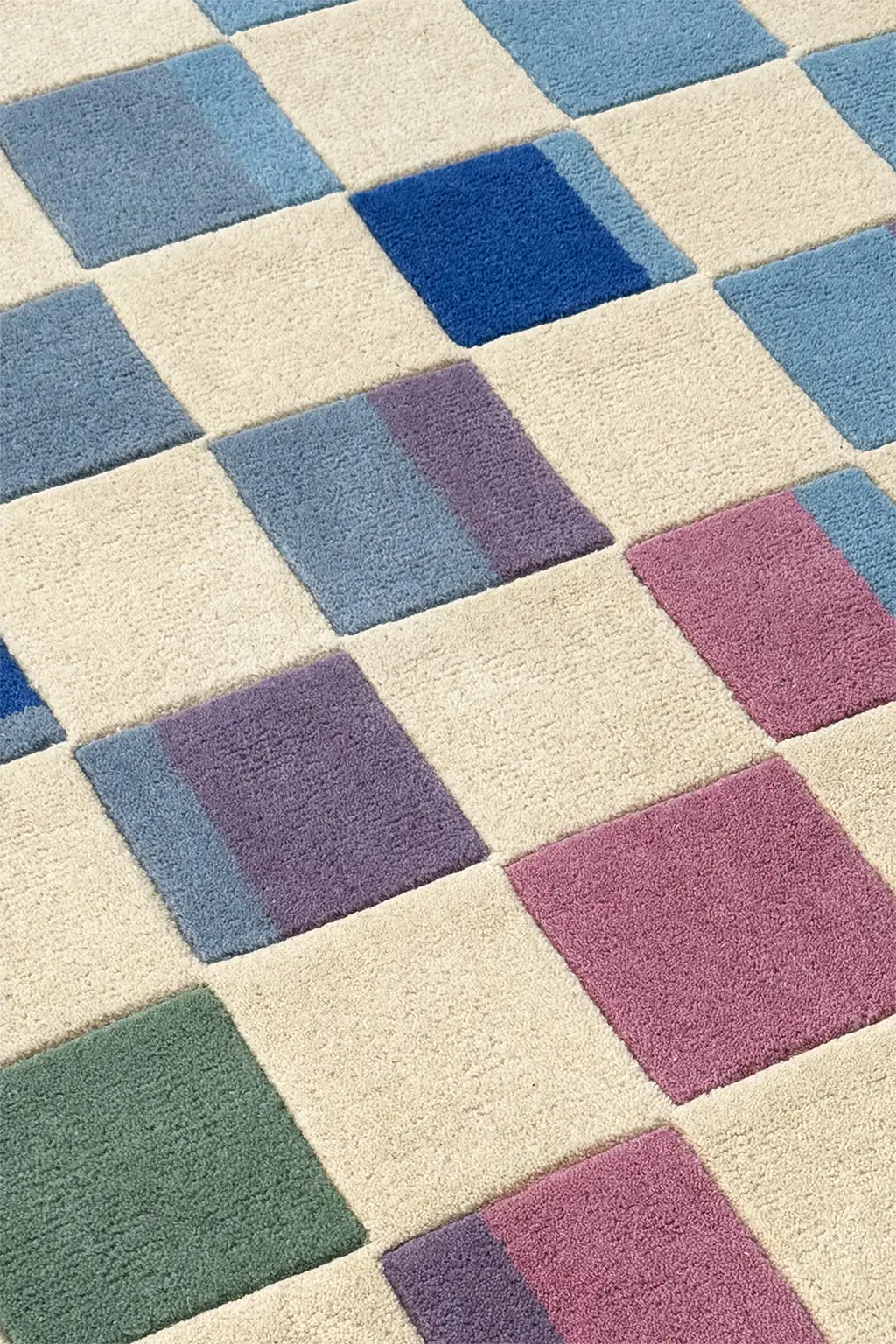 Checkered pattern rug with blue, purple, and green squares on a beige background