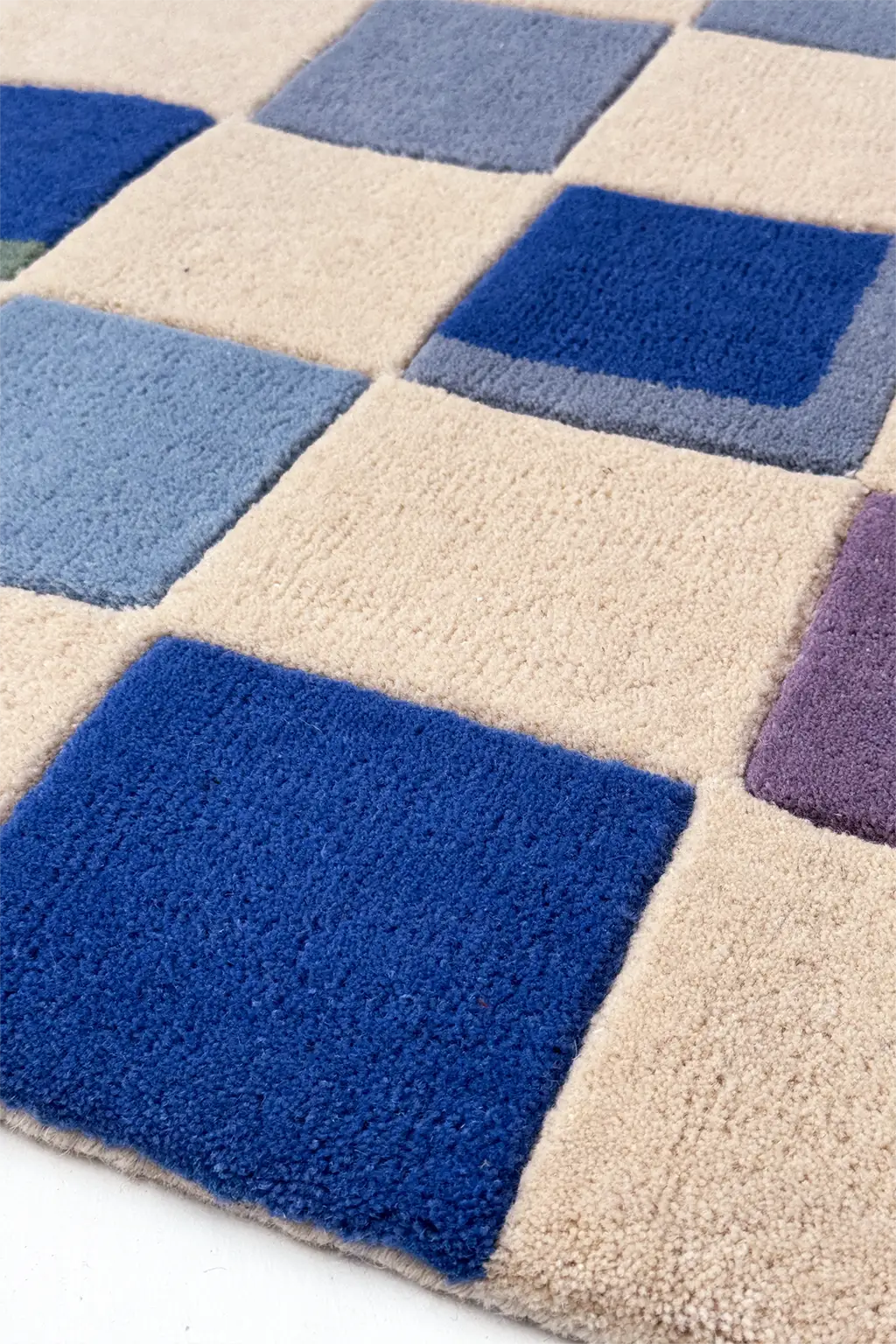 Checkered rug with blue and purple squares on a beige background