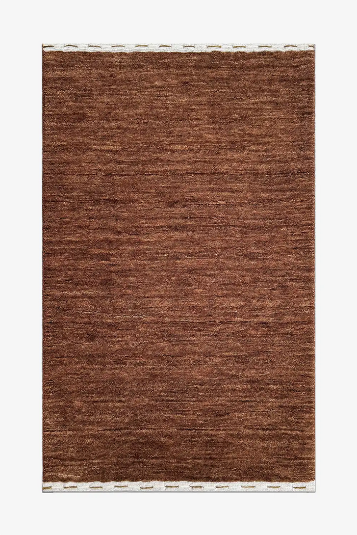 medium brown wool textured rug on a white background chestnut