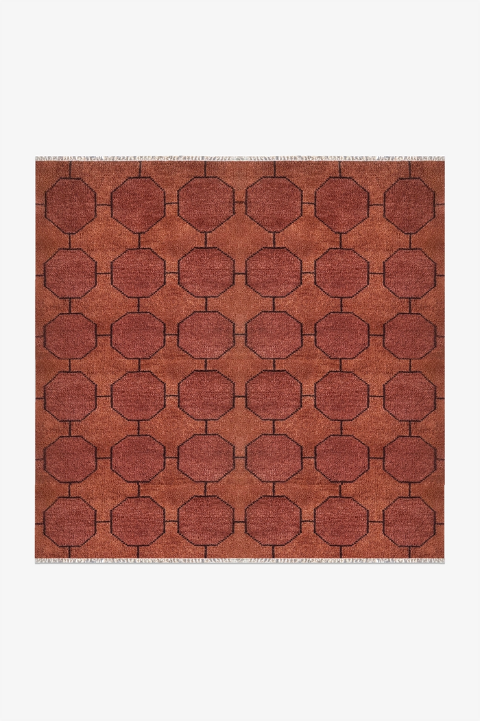 deep rust chestnut geometric square patterned rug on a white background | 6x6