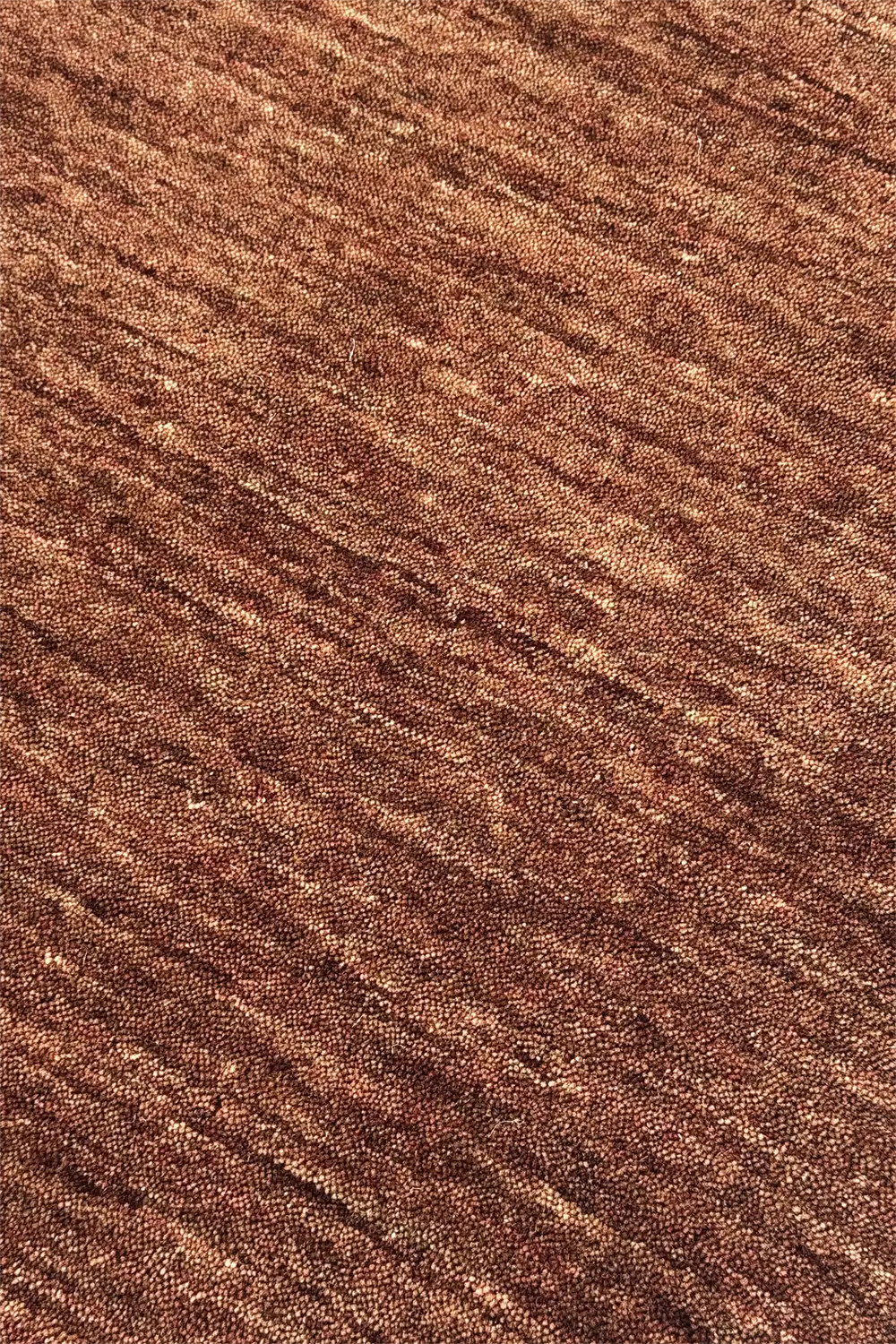 Close-up of brown textured wool area rug modern chestnut