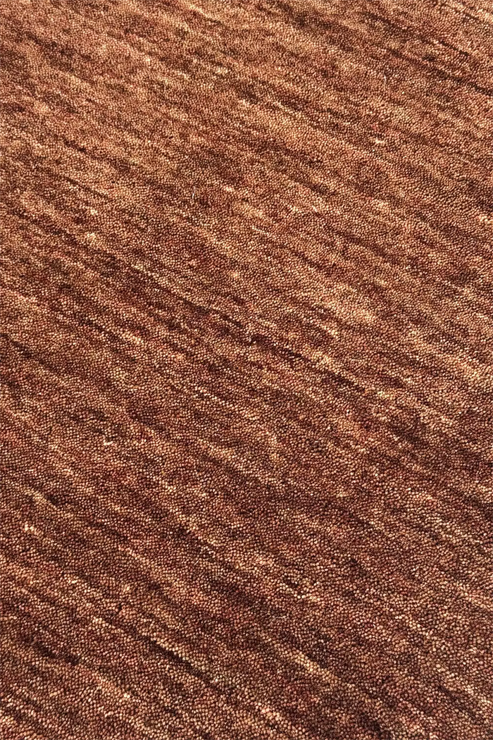 Close-up of brown textured wool area rug modern chestnut