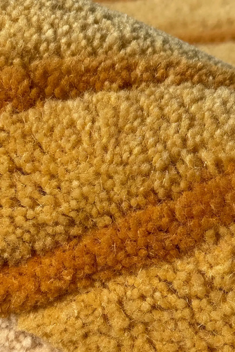 Close-up of a textured gold and yellow carpet