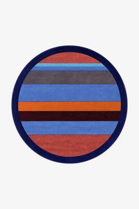 Round rug with multicolored stripes on a white background