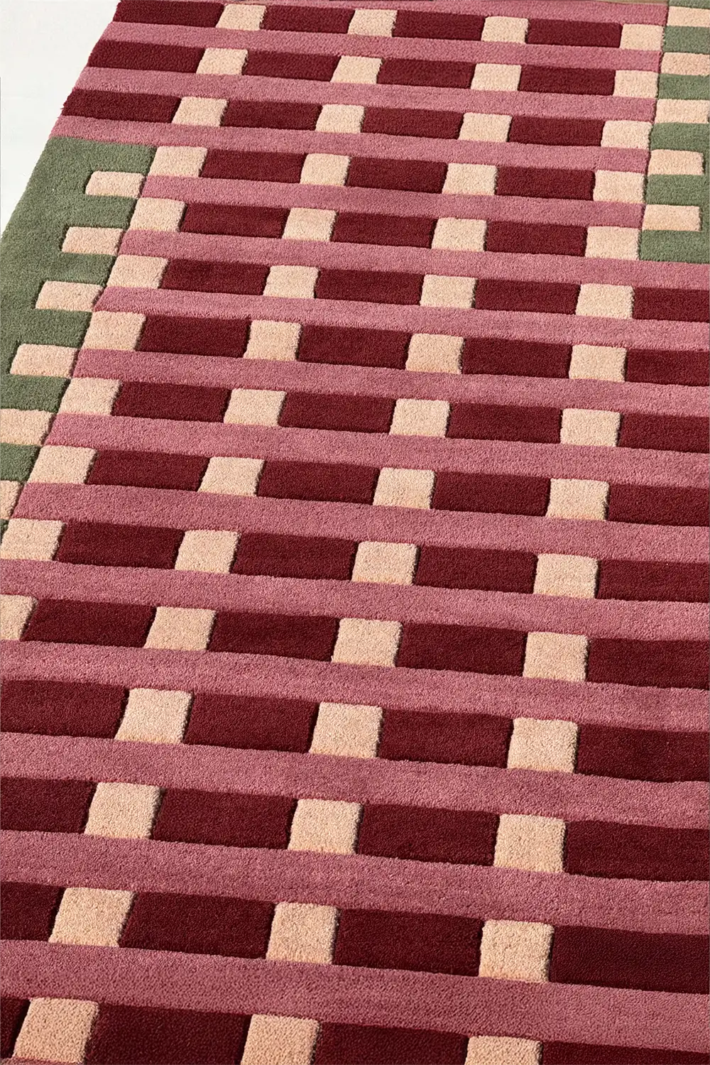 Patterned wool modern rug with red, beige, and green colors