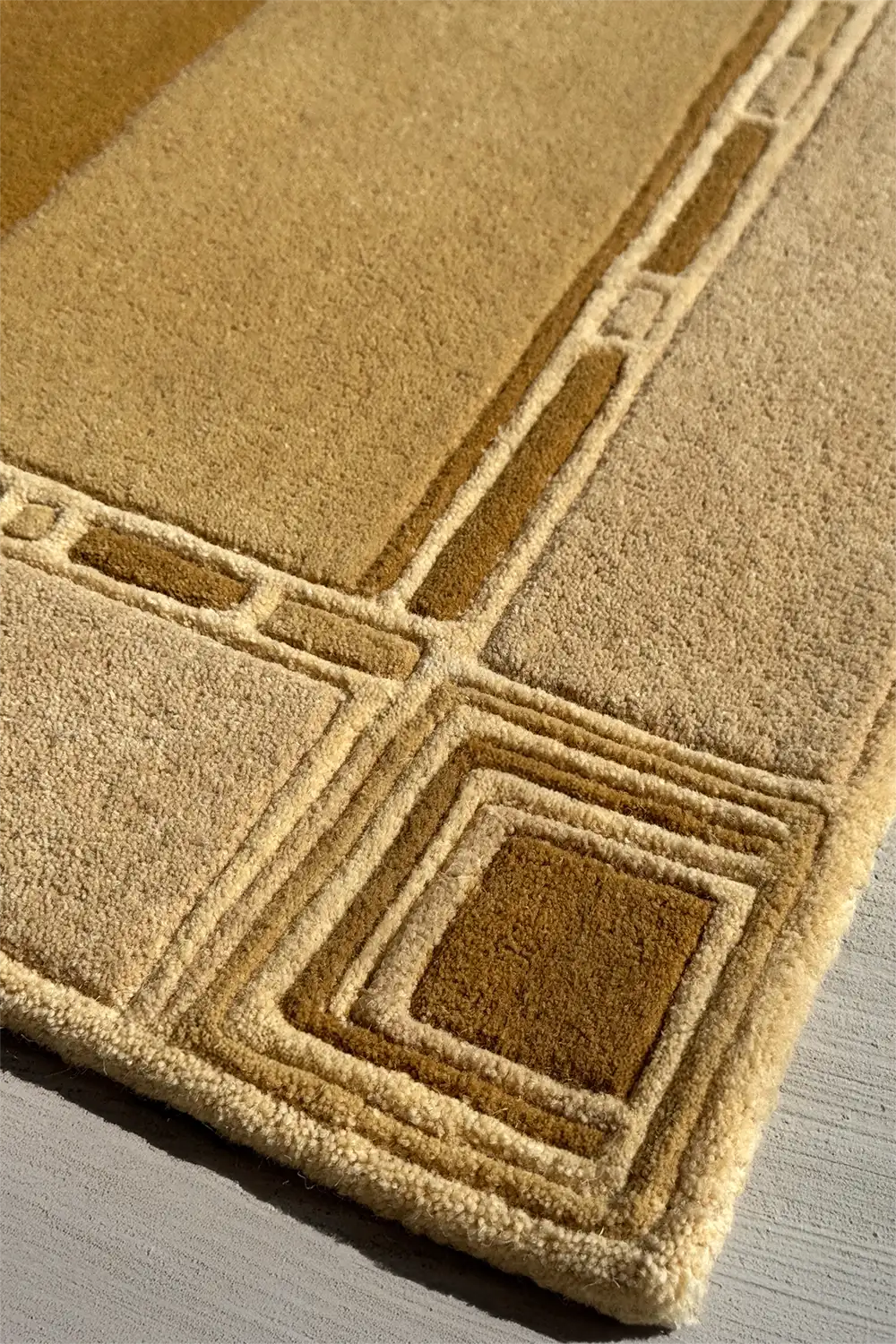 Flat view of abstract rectangular section on architectural rug, combining modern minimalism with warm golden tones