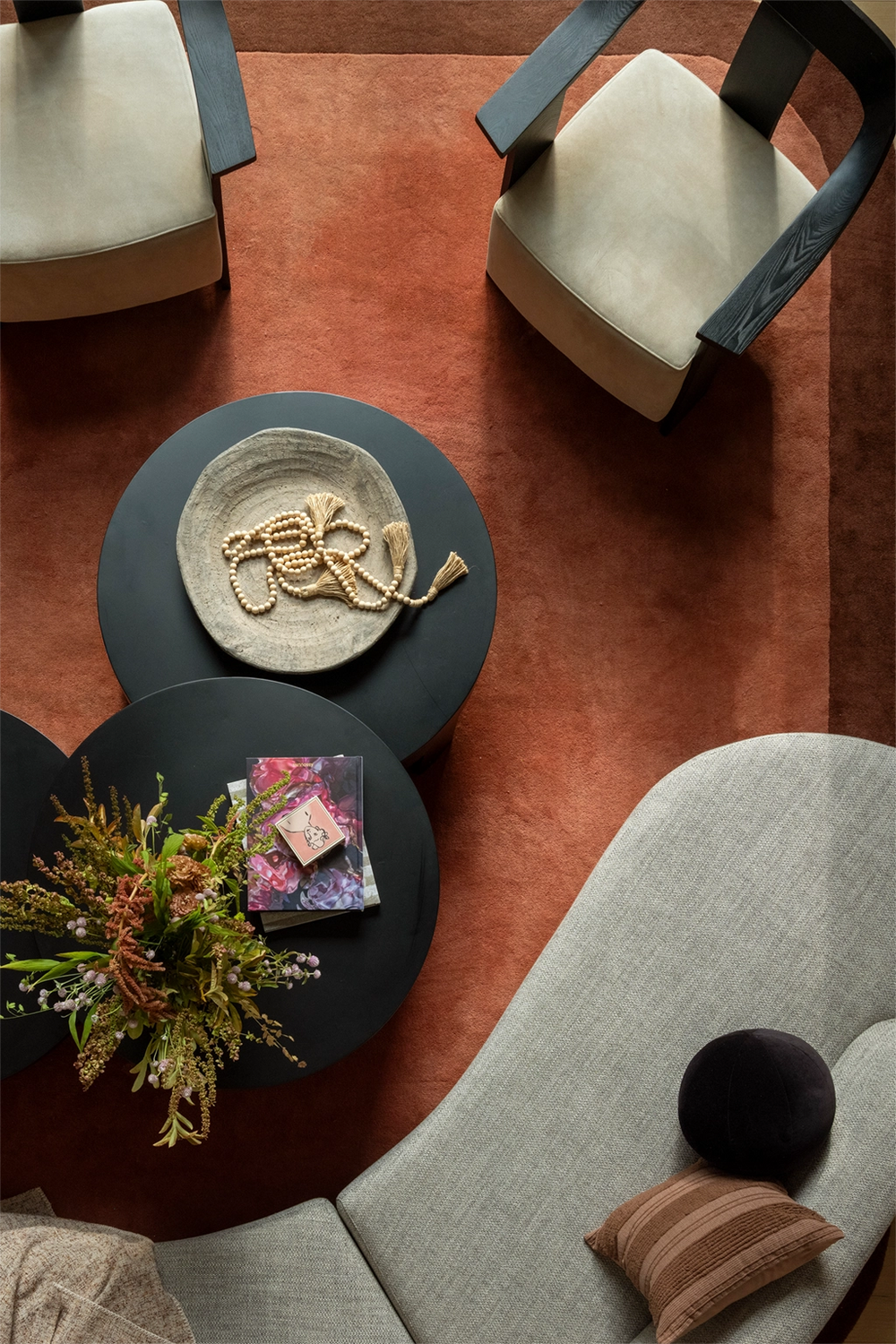 modern living room with warm rusty brown wool rug with dark curved border lifestyle