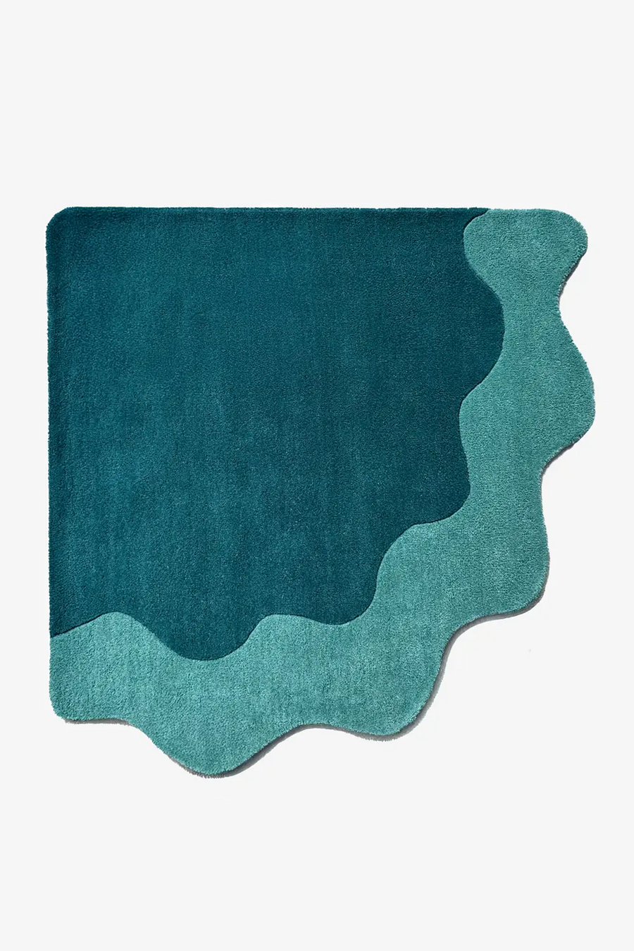 Teal and turquoise corner rug with scalloped curved edge, a modern quarter-circle carpet design for bold, artsy reading nooks or playful corners