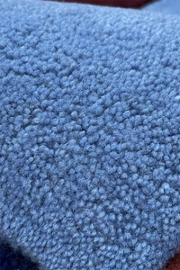 Close-up of cornflower blue hand tufted wool rug