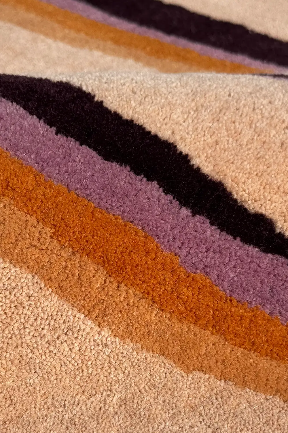 Close-up of a textured wool rug with multicolored stripes in retro style