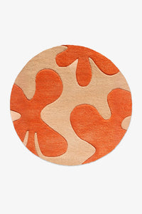 custom round rug orange and beige abstract flower design on a white background