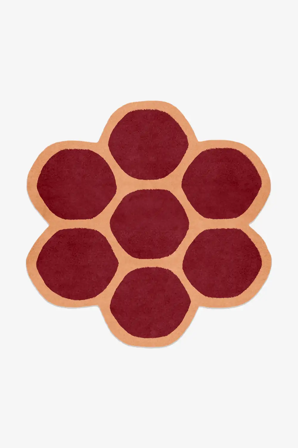Round rug with a flower pattern in red and orange on a white background