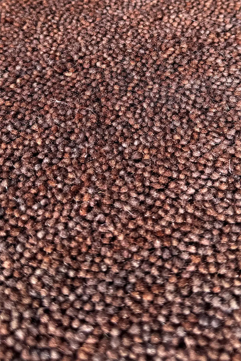 Close-up of dark chocolate brown textured wool carpet