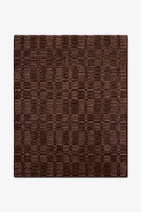 Brown textured wool rug on a white background