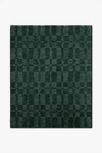 Dark green textured rug on a white background