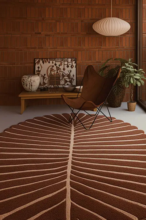 Living room with a brown and white abstract rug, butterfly chair, and wooden wall.