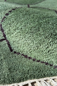 Custom geometric wool rug in deep green with hand-knotted octagon grid design