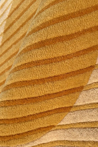 Close-up of a textured gold and beige wool runner rug with japandi style