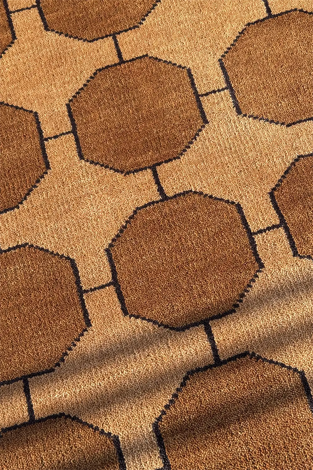 Close-up of a gold brown rug with geometric pattern