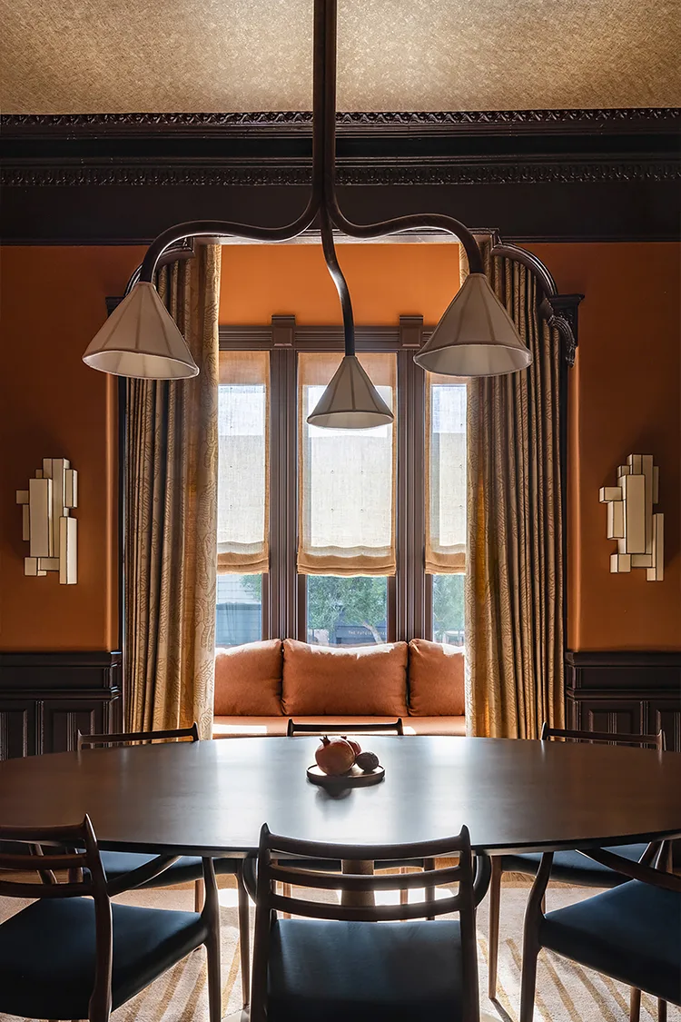 Dining room with wooden table, chairs, and decorative elements.