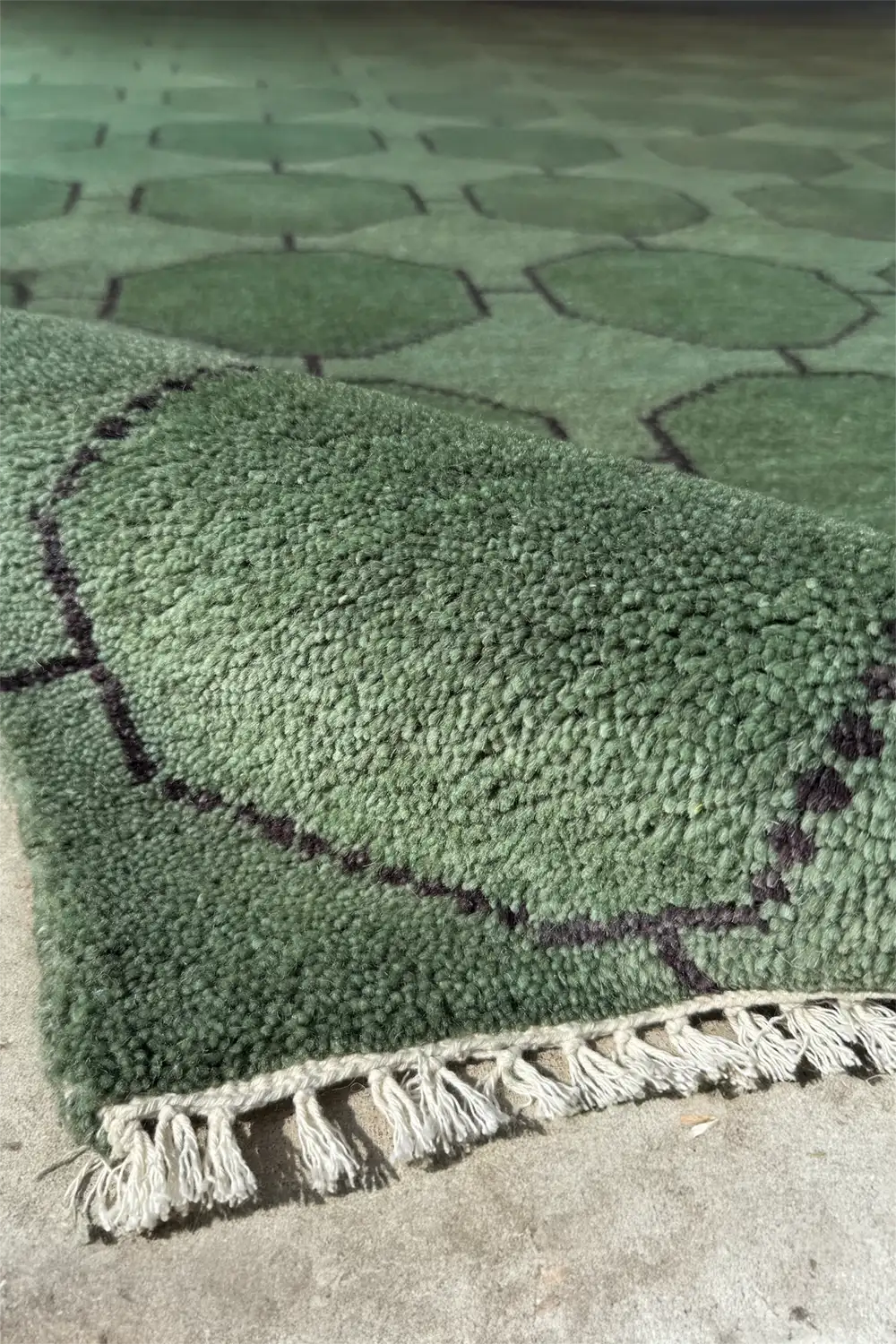 Mid-century inspired green wool area rug with modern geometric shapes