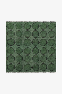 Green geometric patterned square rug on a white background