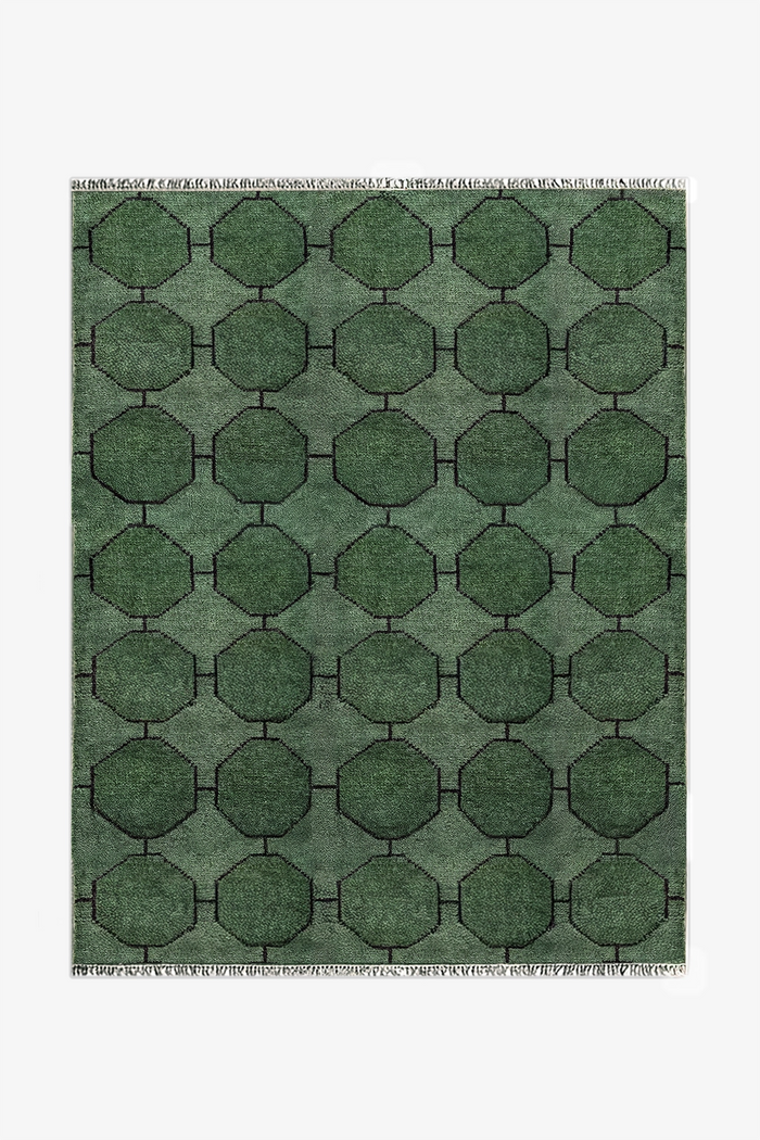 Green geometric patterned rug on a white background