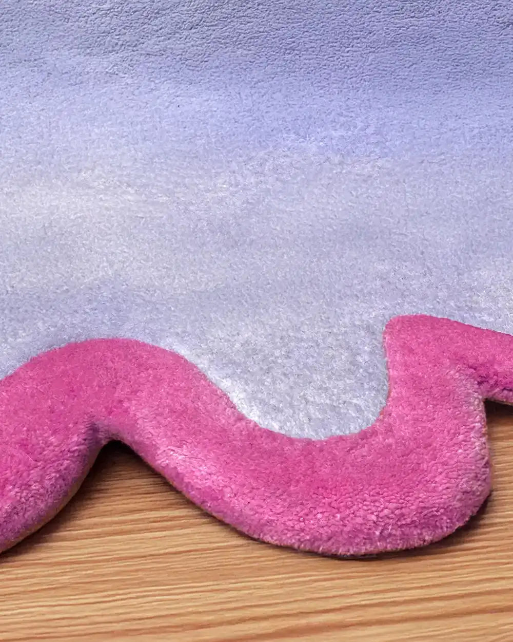close-up texture of a pink and purple unique scalloped wool handmade rug