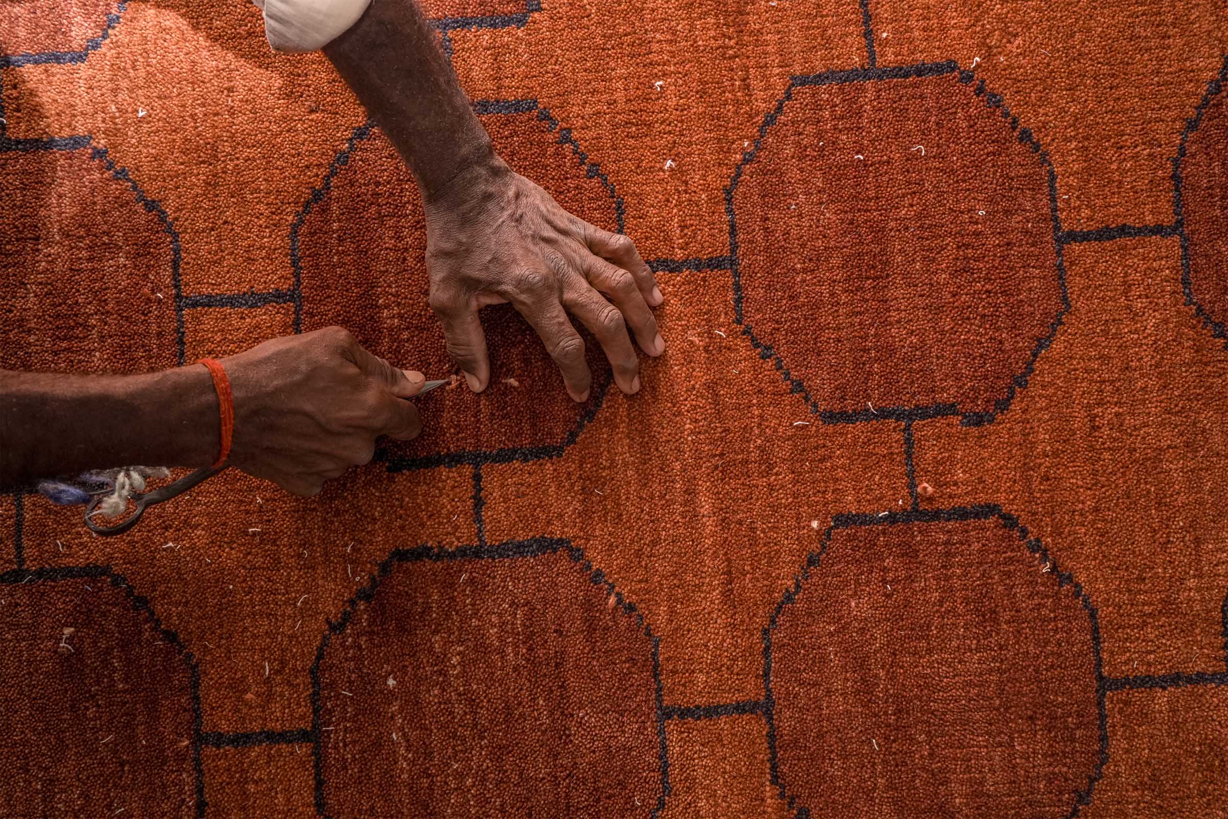 A finished Jubi rug coming off the loom in Bhadohi, India