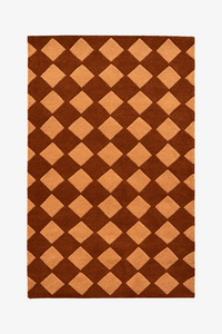 Rug with brown and orange diamond checkered pattern on a white background