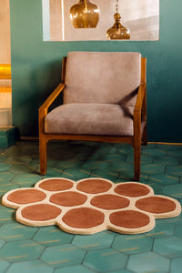 Chair with a decorative geometric patterned wool rug on a teal tiled floor lifestyle | Shown in 3x5