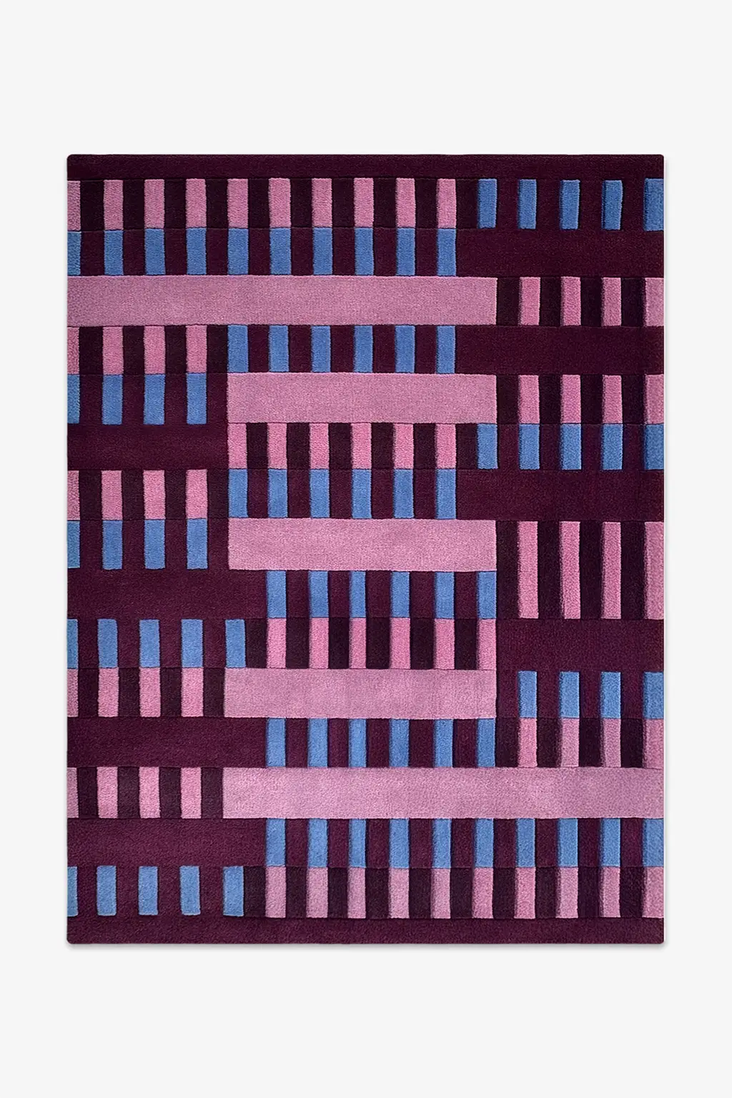 wool rug with a geometric pattern of pink and blue stripes on a dark purple background