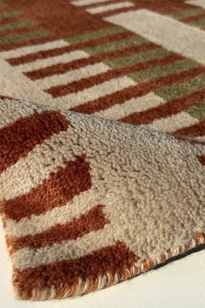 Close-up of a textured mid century rug with geometric pattern multicolor