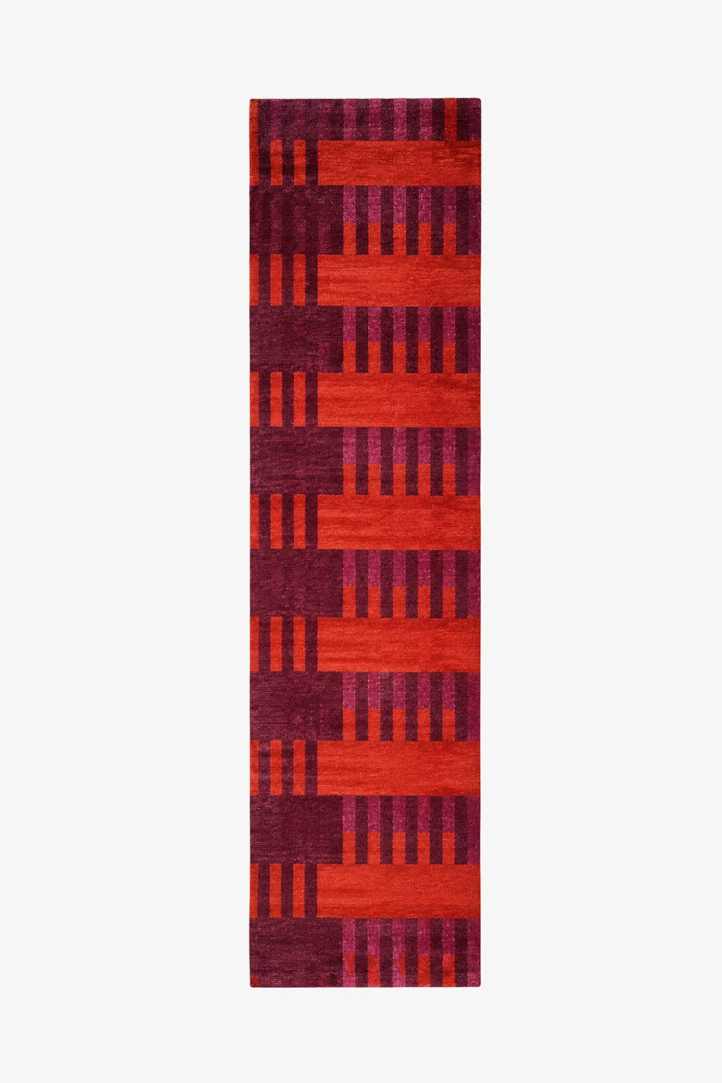 A long runner rug with a geometric pattern of alternating horizontal bands in bright red-orange and deep magenta-purple, featuring vertical stripe motifs.