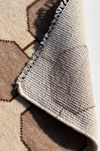 Close-up of a textured ivory cream rug with geometric pattern