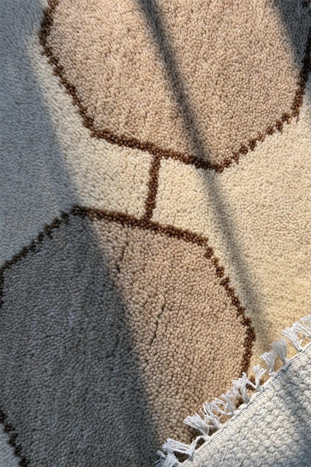 Close-up of a textured contemporary style rug with geometric pattern ivory