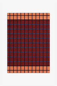 Plaid patterned rug with red, blue, and orange colors on a white background