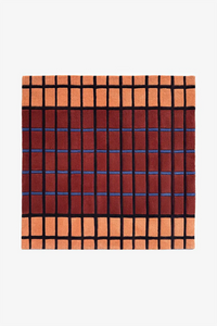 rust square wool rug with terracotta, blue, and black geometric grid mid century inspired